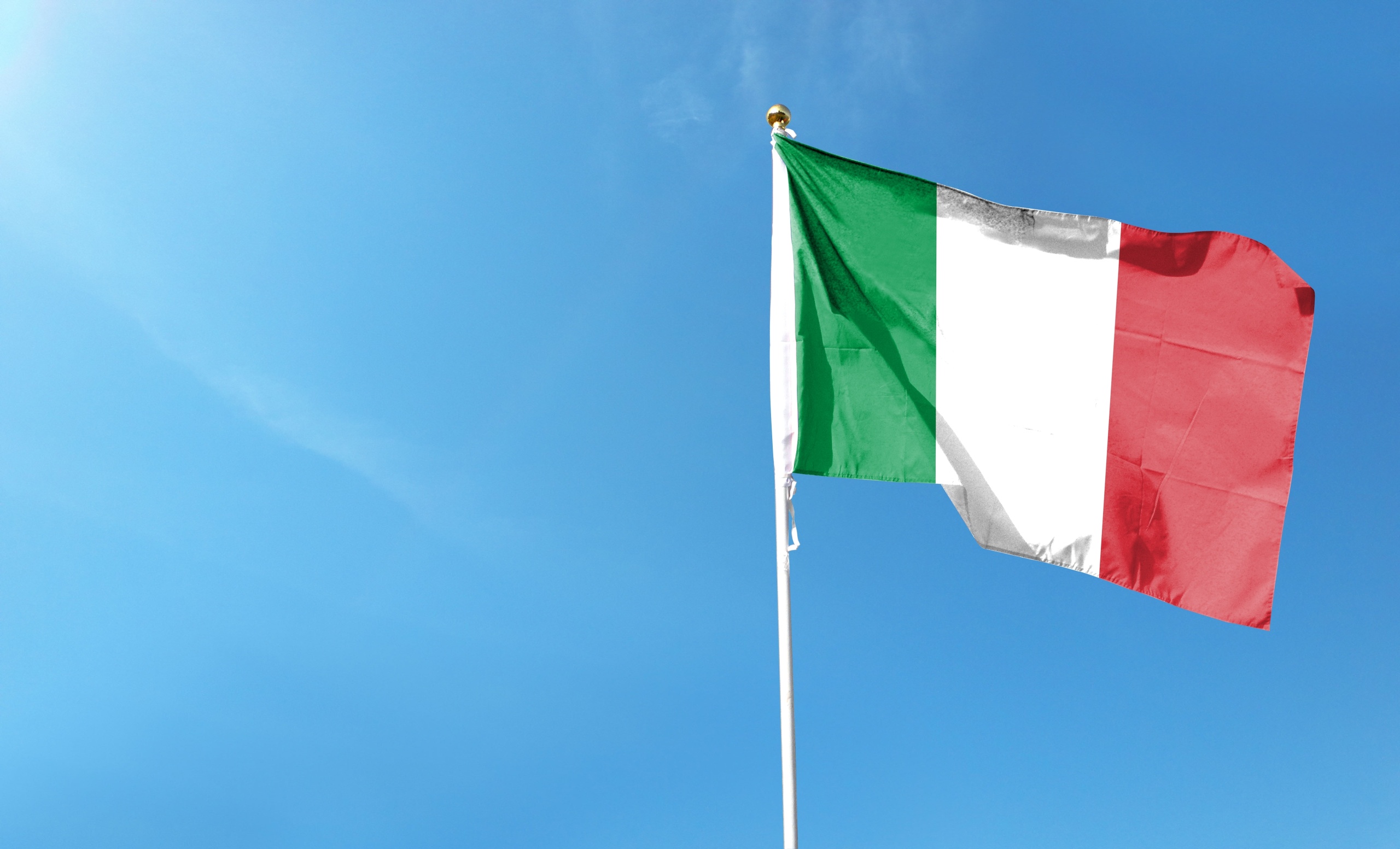Italian flag against a blue sky